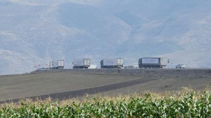 Trucks travel along a road in Armenia