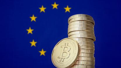 A stack of bitcoin and an EU flag