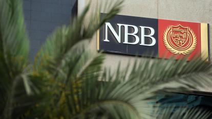 NBB Bank's logo seen through palm leaves