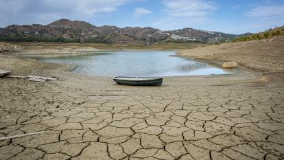 A boat sits grounded in a dwindling reservoir in Malaga, Andalusia, Spain
