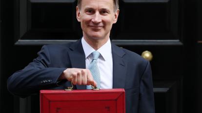 British Chancellor of the Exchequer Jeremy Hunt poses with his budget box outside 11 Downing Street in London