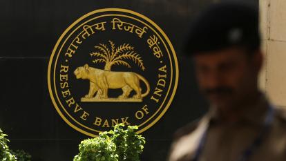 A police officer walks past the Reserve Bank of India logo inside its headquarters in Mumbai, India