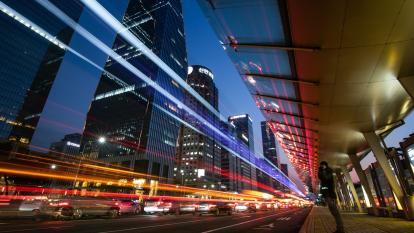 Light trails left by moving traffic run along a road at dusk in the Yeouido financial district of Seoul, South Korea.