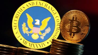 The Securities and Exchange Commission seal behind a stack of physical bitcoins