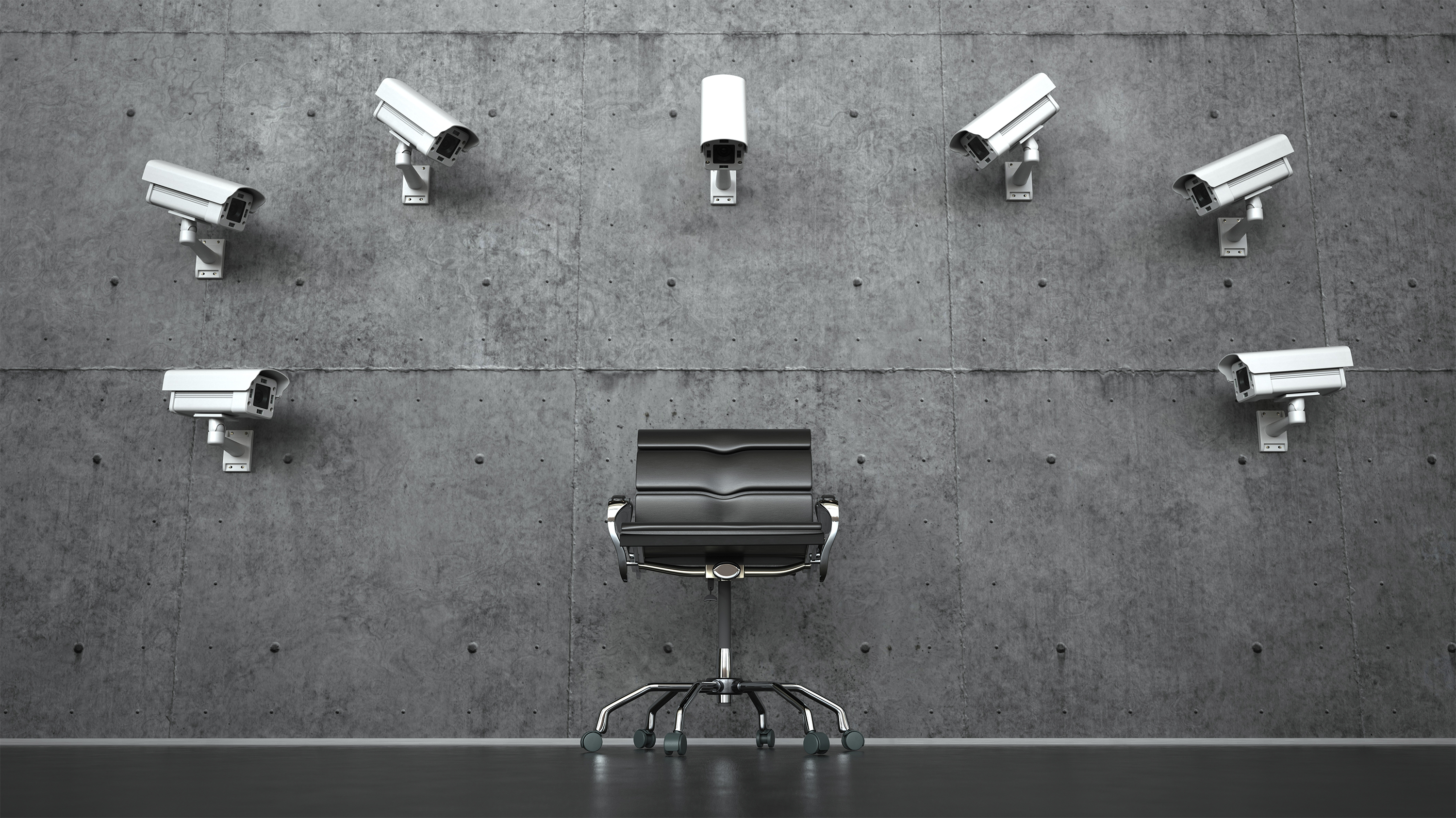 An array of CCTV cameras trained on an empty office chair.