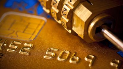 An extreme close-up of a padlock on top of a credit card