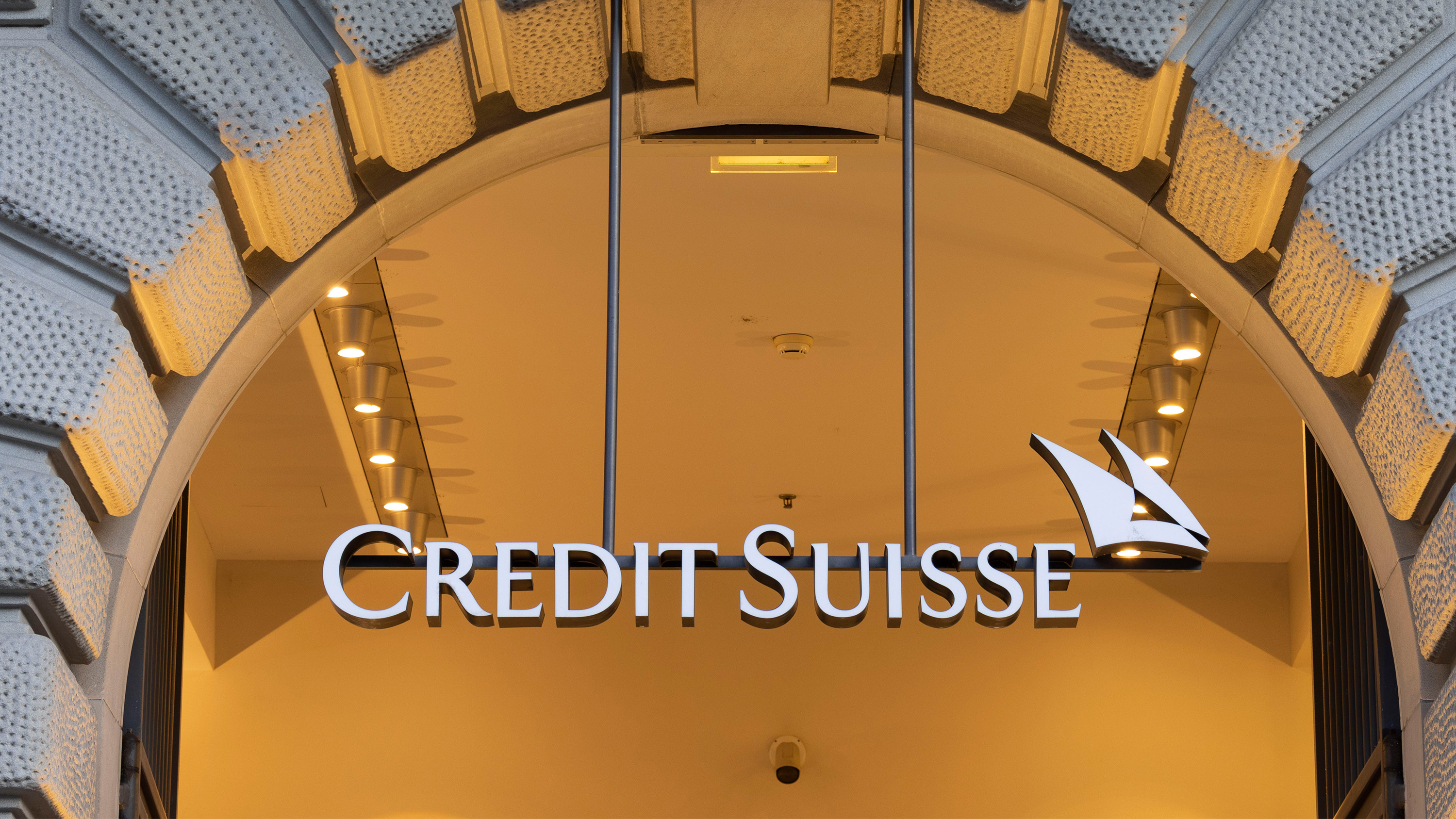 The Credit Suisse logo hanging from an archway.