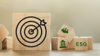 Target symbol and ESG icon on wooden blocks.