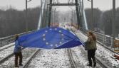 Still on track? The EU flag is carried from Germany to Poland. How long it will take the euro currency to follow suit is up for debate