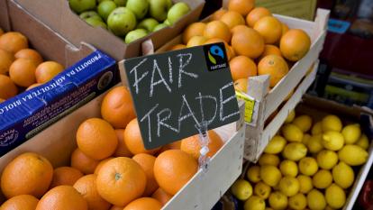 A Fair Trade sign over fresh fruit