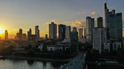 The sun sets over skyscrapers in the financial district of Frankfurt