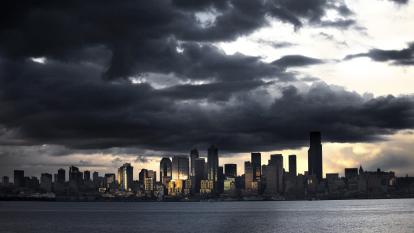 Storm clouds gather over a city skyline