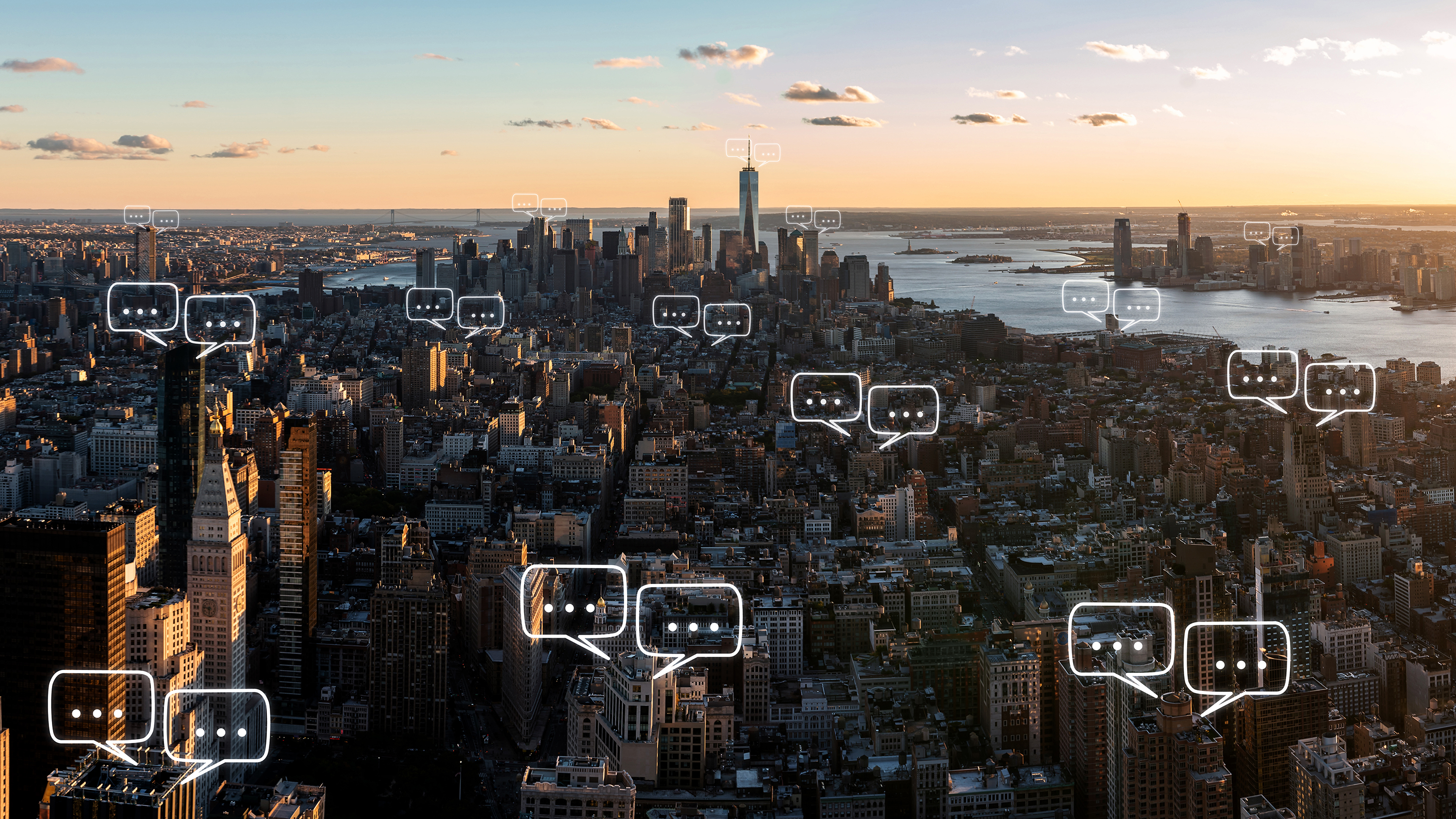 Digital chat bubbles appear across a high view of New York City