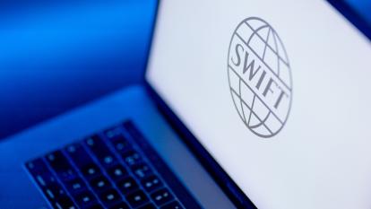 The Society for Worldwide Interbank Financial Telecommunication (SWIFT) company logo displayed on a laptop