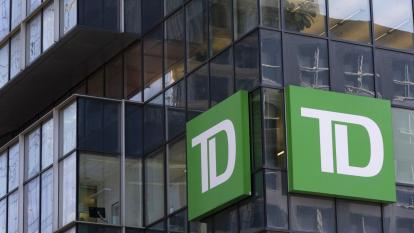 An exterior shot of glass-panelled TD Bank offices, with its logo affixed to the facade.